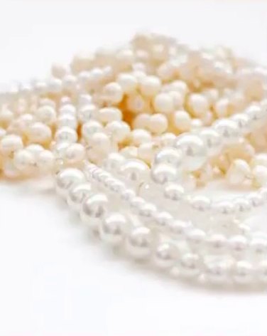 A tumble of real pearl strands photographed on white, from the SADAF collections page